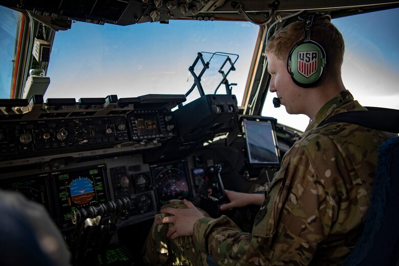 A U.S. Air Force pilot flies a C-17 Globemaster III assigned to the 16th Airlift Squadron, Joint Base Charleston, Charleston, South Carolina, supporting Combined Joint Task Force-Horn of Africa, in Maputo, Mozambique, April 2, 2019. The task force is helping meet requirements identified by the United States Agency for International Development (USAID) assessment teams and humanitarian organizations working in the region by providing logistics support and manpower to USAID at the request of the Government of the Republic of Mozambique. (U.S. Air Force Photo by Tech. Sgt. Chris Hibben)