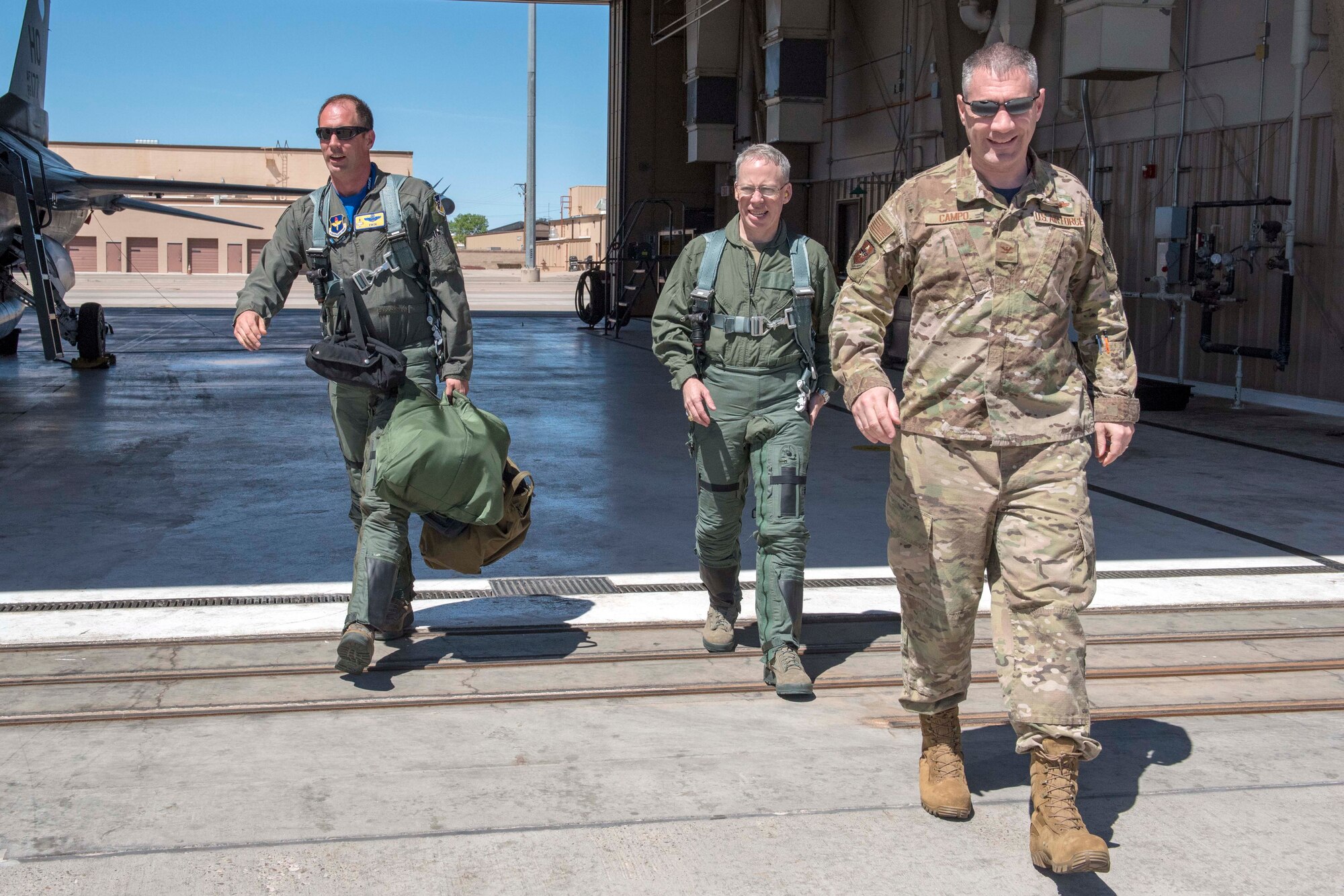 U.S. Air Force Col. Joseph Campo, 49th Wing commander (right), and Lt. Col. Peter Kasarskis, 54th Fighter Group deputy commander (left), escort U.S. Army Brig. Gen. Gregory Brady, White Sands Missile Range commander, after his familiarization flight in the F-16 Fighting Falcon, April 19, 2019, on Holloman Air Force Base, N.M. Brady visited the base to gain a better understanding of the everyday mission here at Holloman. (U.S. Air Force photo by Staff Sgt. Christine Groening)