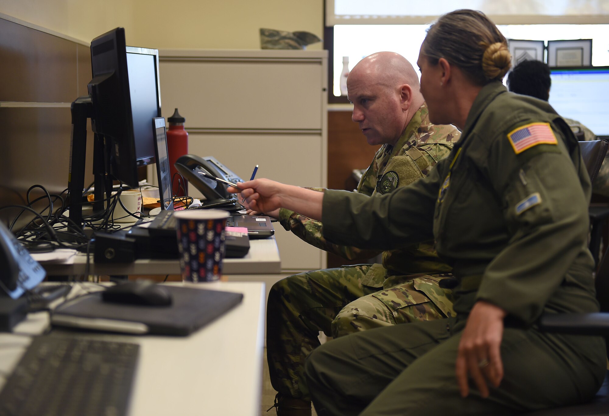 Chief Master Sgt. Stephanie Northup, 7th Airlift Squadron chief enlisted manager, far right, in-briefs Chief Master Sgt. Will Palmer, her replacement as the chief enlisted manager for McChord operations at March Air Reserve Base in California, March 2, 2019.