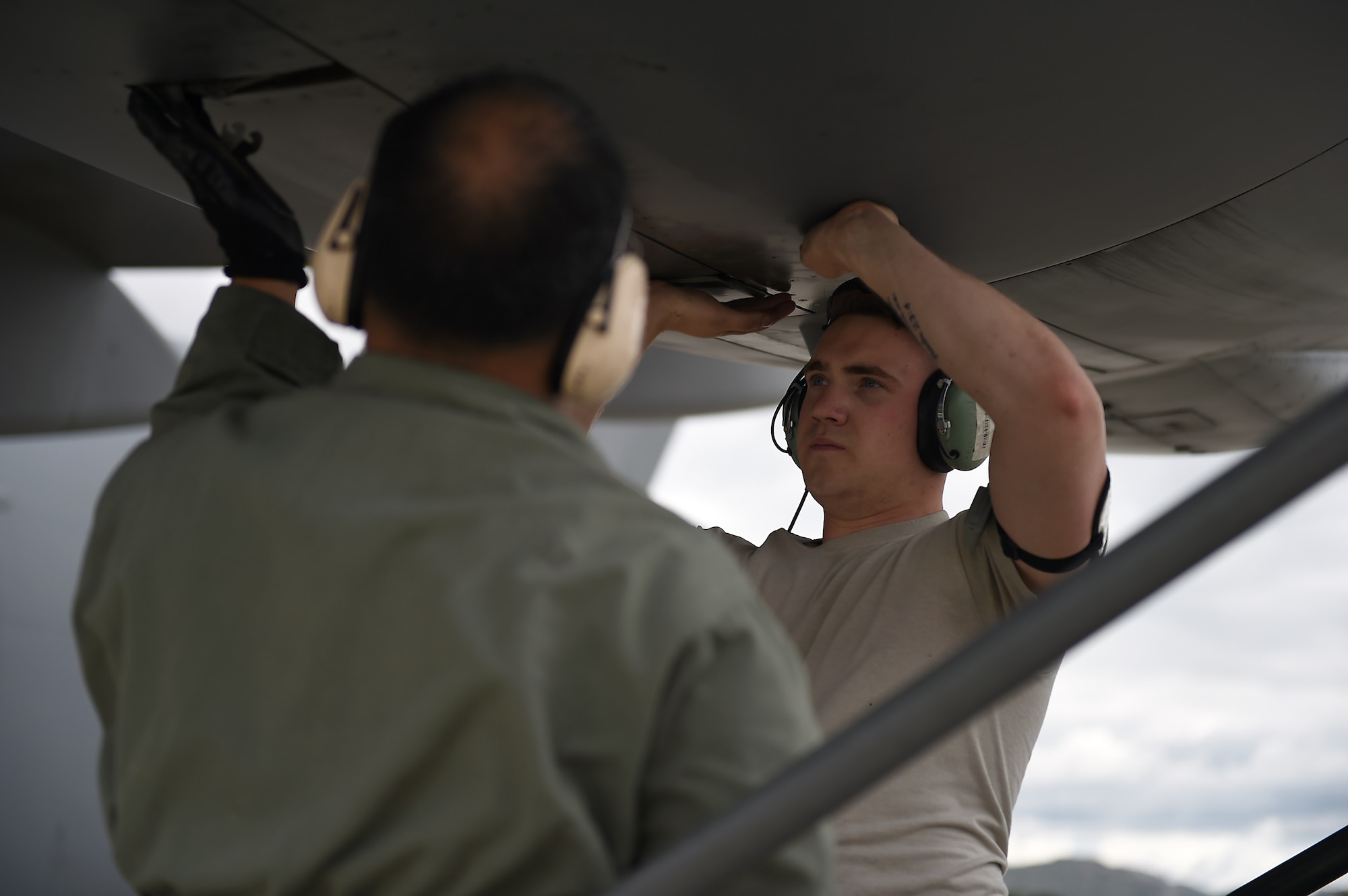 Master Sgt. Ruel Lechadores, 446th Aircraft Maintenance Squadron crew chief, and Airman 1st Class Conner Bentley, 62nd Aircraft Maintenance Squadron crew chief, close up the outside of an engine on a C-17 Globemaster III, April 3, 2019, on March Air Reserve Base in California.