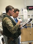 Hospital Corpsman 2nd Class Richard Derrick, assigned to the Island Knights of Helicopter Sea Combat Squadron (HSC) 25 speaks with a medical representative.  HSC-25 maintains a 24-hour search and rescue and medical evacuation alert posture, directly supporting the U.S. Coast Guard, Sector Guam and Joint Region Marianas. HSC-25 ensures maritime peace and security in the U.S. 7th Fleet area of responsibility.