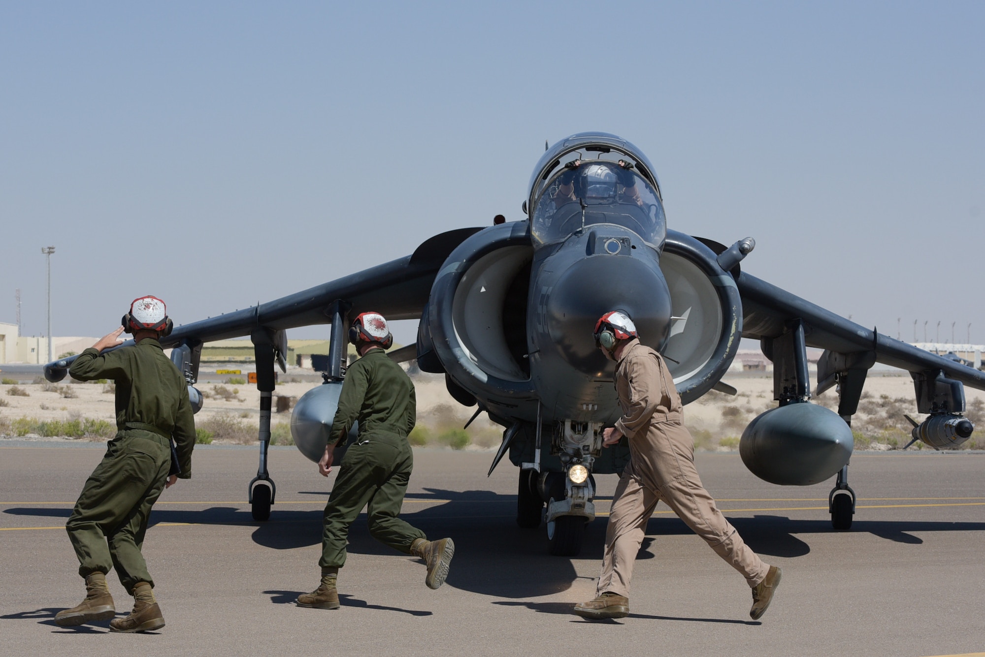 Maintainers from the 22nd Marine Expeditionary Unit run from wing to wing to de-arm ordnance from the AV-8B Harrier II after landing April 16, 2019, at Al Dhafra Air Base, United Arab Emirates.