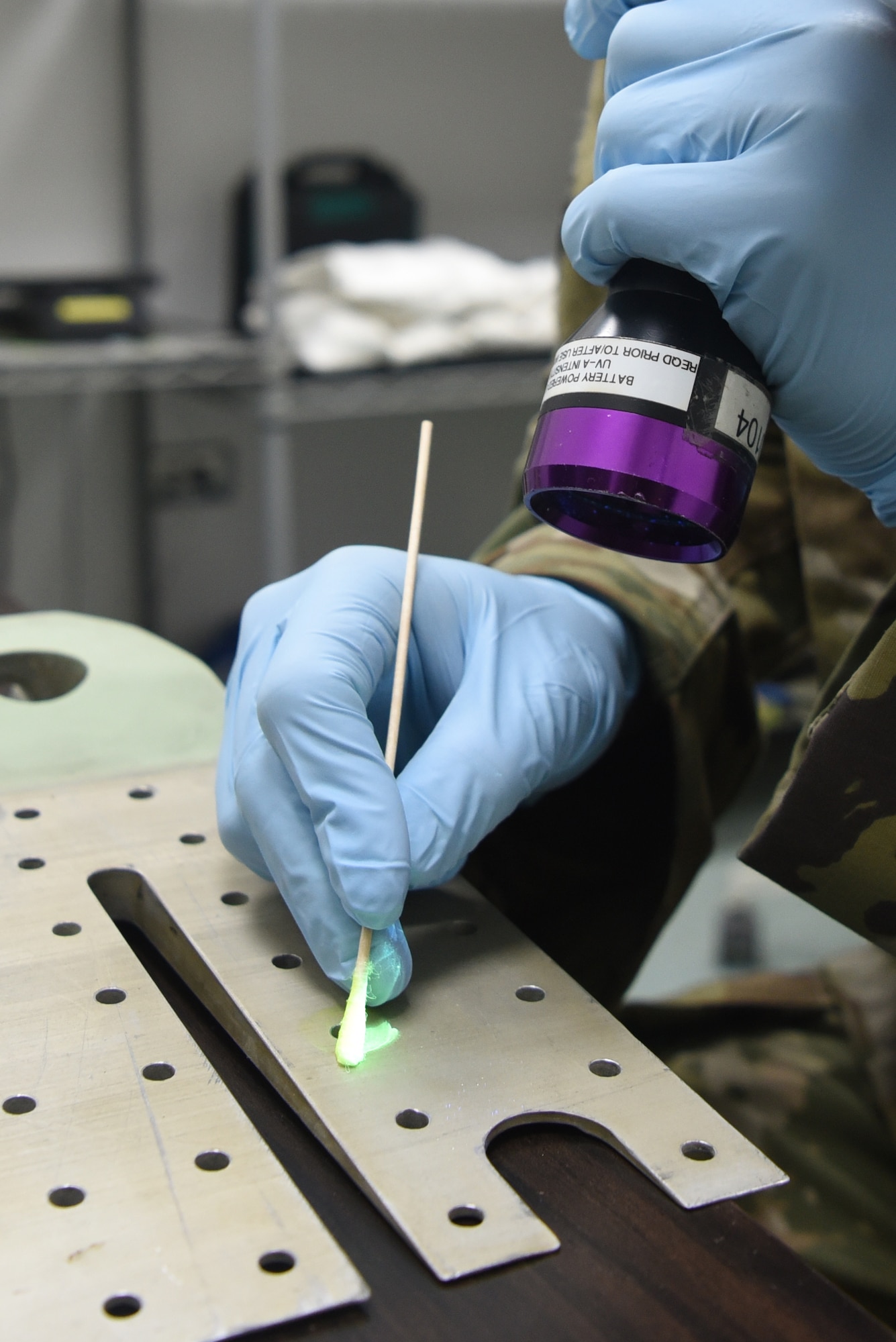 Senior Airman Jared Allen, 380th Expeditionary Maintenance Squadron Nondestructive Inspection journeyman, demonstrates the use of penetrant, April 12, 2019, on Al Dhafra Air Base, United Arab Emirates.