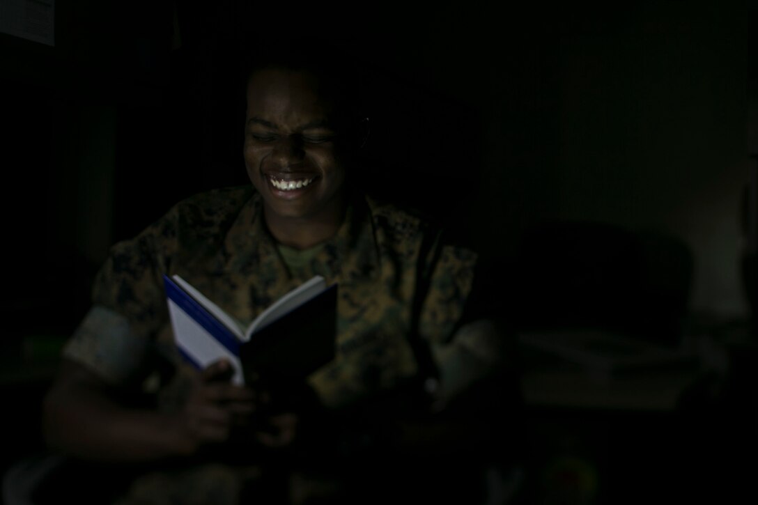 Lance Cpl. Tayvion Smith, a legal clerk with the 31st Marine Expeditionary Unit, reads a book at Camp Hansen, Okinawa, Japan, April 11, 2019. Smith, a native of Columbus, Ohio, enlisted in November of 2017 after graduating from Eastmoore Academy. He joined for the camaraderie and to continue his education. The 31st MEU, the Marine Corps’ only continuously forward-deployed MEU, provides a flexible force ready to perform a wide range of military operations as the premier crisis response force in the Indo-Pacific region. (U.S. Marine Corps photo be Lance Cpl. Cameron Parks/Released)