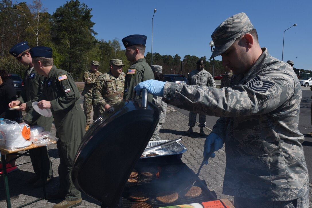 U.S. Air Force Tech. Sgt. Lance Stultz, 721st Aircraft Maintenance Squadron equipment program management, grills burgers for the Air Force Assistance Fund “Burger Burn” April 18, 2019 on Ramstein Air Base, Germany. The Air Force Assistance Fund is an annual effort to raise funds for four charities that directly support Airmen in need. (U.S. Air Force photo by Airman 1st Class Kaylea Berry)