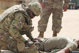 Spc. Shadarius Robinson treats a mock casualty during a Combat Lifesaver course conducted by the 300th Sustainment Brigade at Camp Arifjan, Kuwait, April 19, 2019.