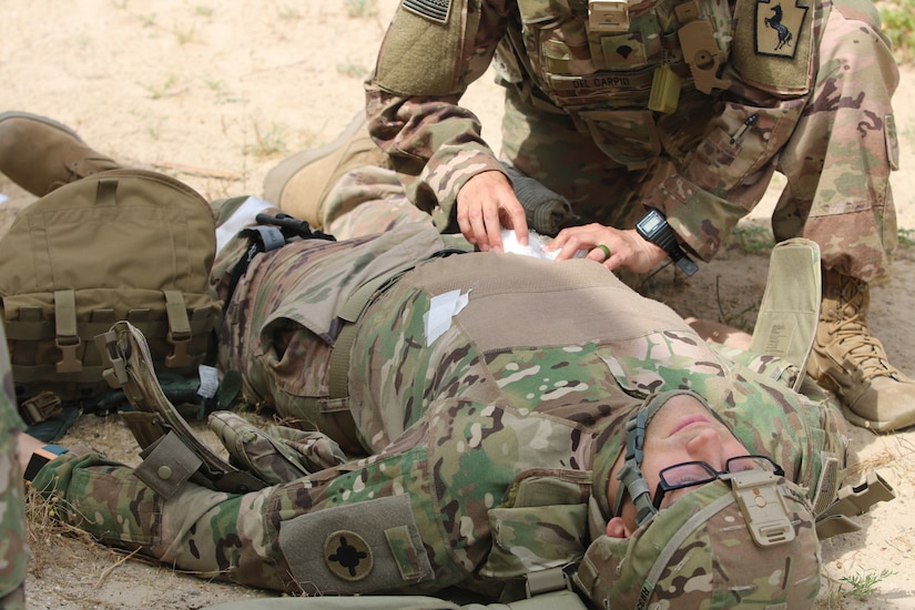 Spc. Sasha Del Carpio Torres, 28th Military Police Company, treat a wound on a mock casualty during a Combat Life Saver course held by the 300th Sustainment Brigade at Camp Arifjan, Kuwait, April 19, 2019.
