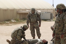 Spc. Shadarius Robinson, 184th Sustainment Command, treats a mock casualty during testing for the Combat Life Saver course held by the 300th Sustainment Brigade at Camp Arifjan, Kuwait, April 19, 2019.