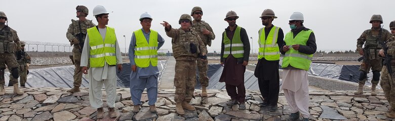 Mr. James Fielden pointing out the layout of the facility in front of the Settling Pond #2 to the Romanian Guardian Angels and MSG Galmines (USACE Guardian Angel) and TAAC-Air (Customer)