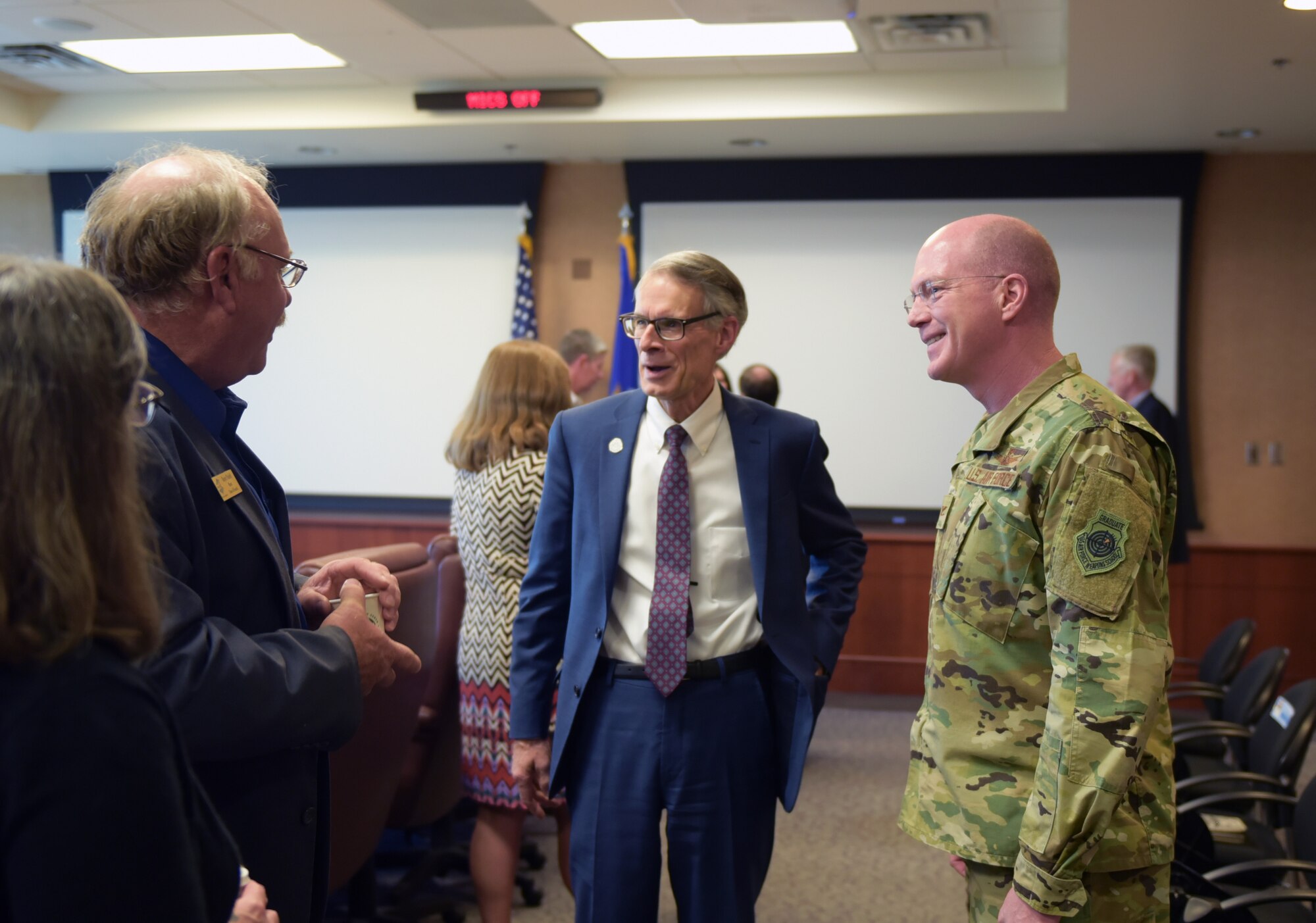 From left to right, Bob Muckle, mayor of Louisville, Bob LeGare, mayor of Aurora, and Col. Troy Endicott, 460th Space Wing commander, greet one-another at the Mayors Day at Buckley Air Force Base, Colorado, April 19, 2019.
