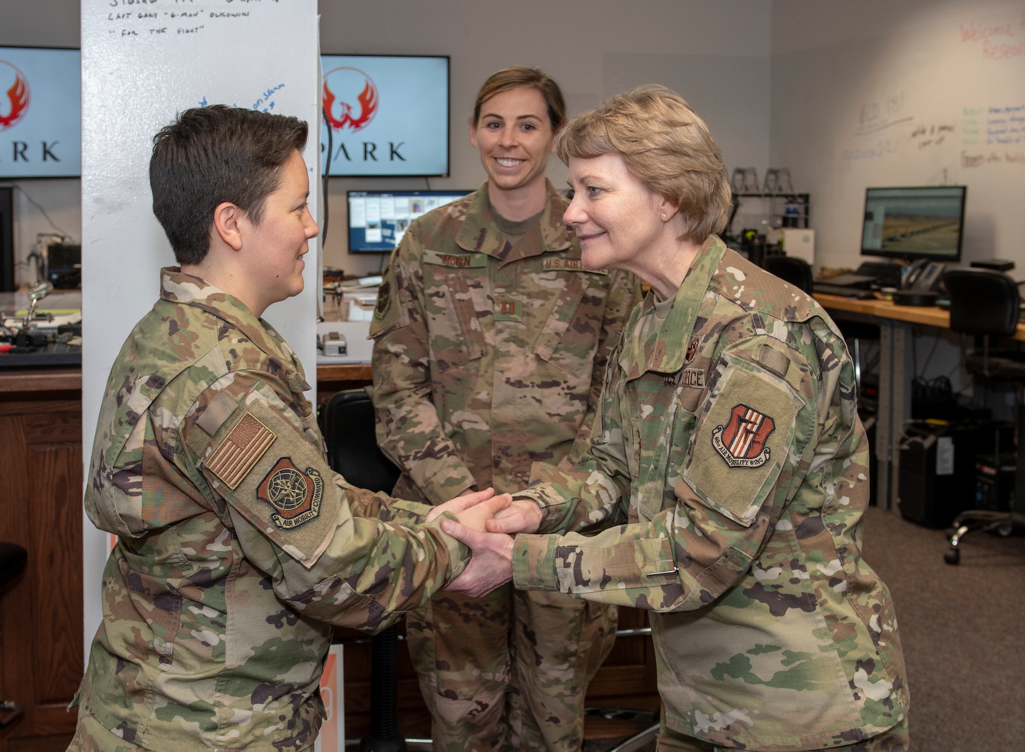 U.S. Air Force Gen. Maryanne Miller, Air Mobility Command commander, right, presents a coin to Staff Sgt. Amber Carter, left, 60 Air Mobility Wing Public Affairs photojournalist, in recognition of her superior performance during a visit to the Phoenix Spark innovation facility at Travis Air Force Base, California, April 16, 2019 as Capt. Lyndsey Horn, PA chief looks on. During the four-day base visit Miller and Chief Master Sgt. Terrence Greene, AMC command chief, met with Airmen across Travis to see how the base enhances AMC’s global mobility capabilities. (U.S. Air Force photo by Heide Couch)