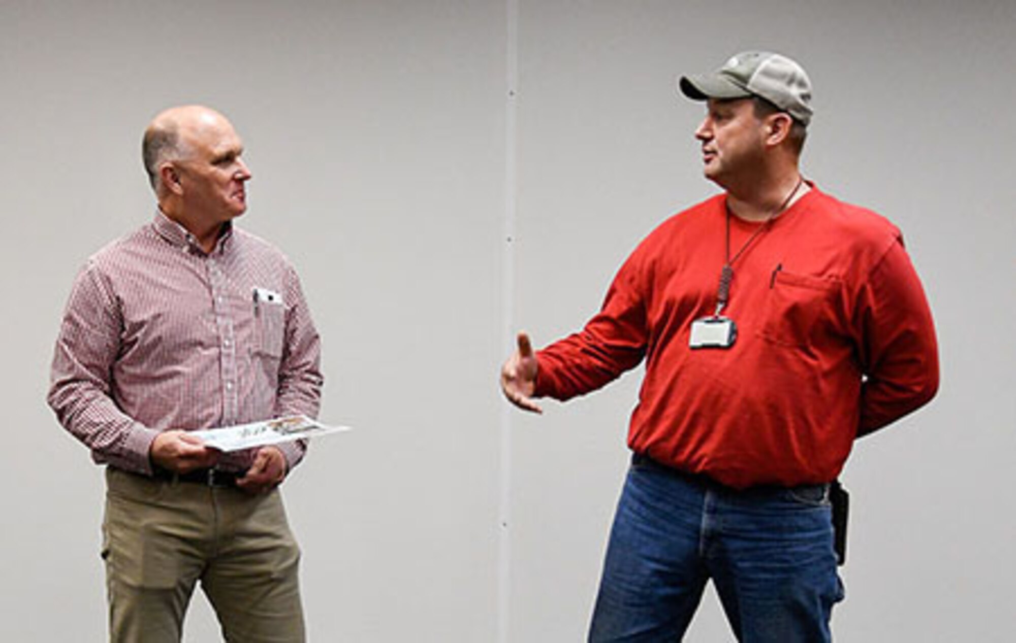 Casey Culver, right, a pipefitter at Arnold Air Force Base, talks about assisting a fellow Arnold employee after finding her stranded on the side of a road, before being presented April 12 at the base with a certificate of recognition and coin for his deed by Ronnie Skipworth, director of base operations and support for the Test Operations and Sustainment contract. (This image has been altered by obscuring a badge for security purposes.) (U.S. Air Force photo by Jill Pickett)