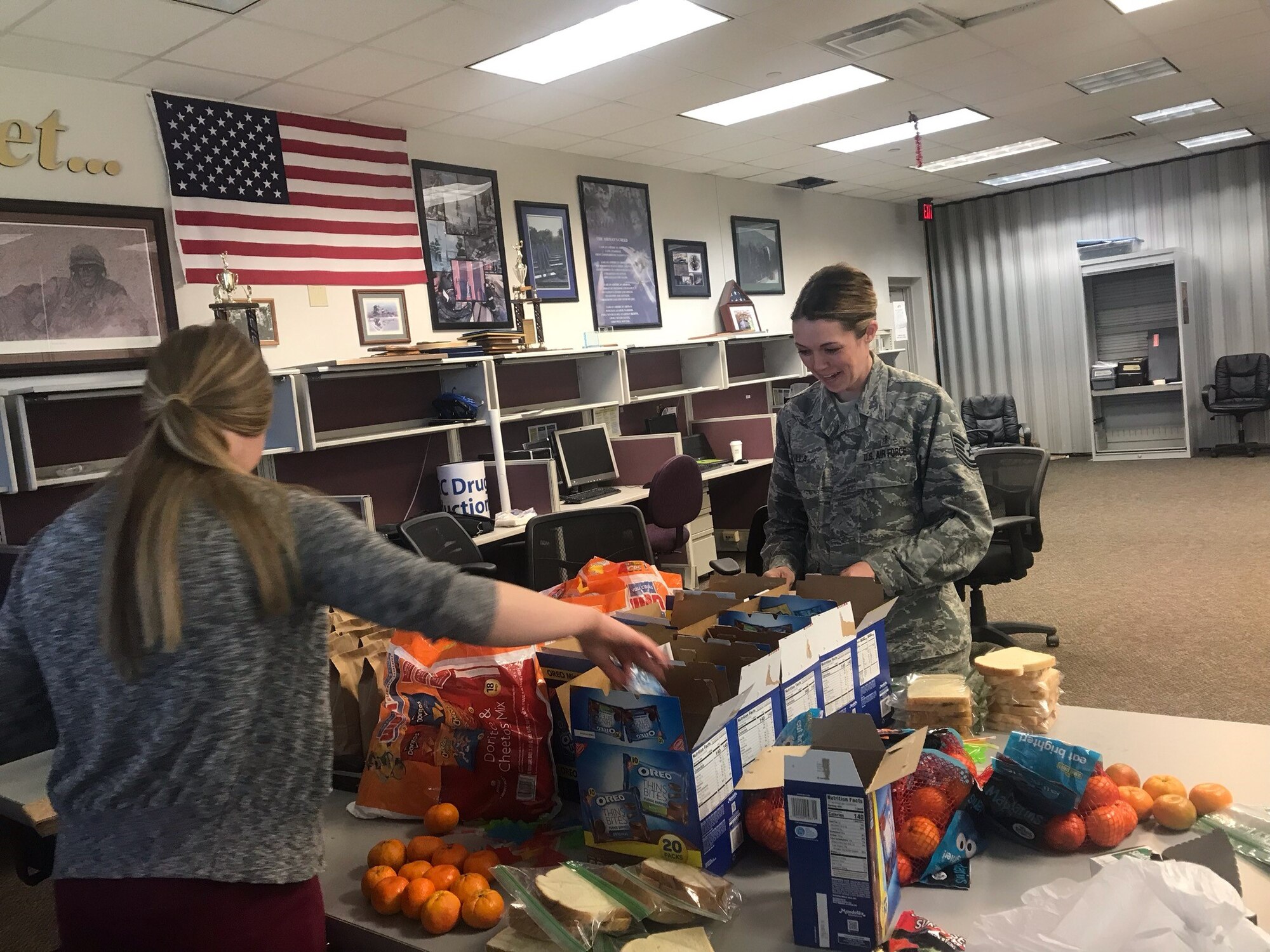 Tech. Sgt. Adrian Villa (right) and Senior Airman Hayley Sewell, reservists in the 419th Medical Squadron, pack sack lunches to be delivered April 19 to homeless children in the Salt Lake City area