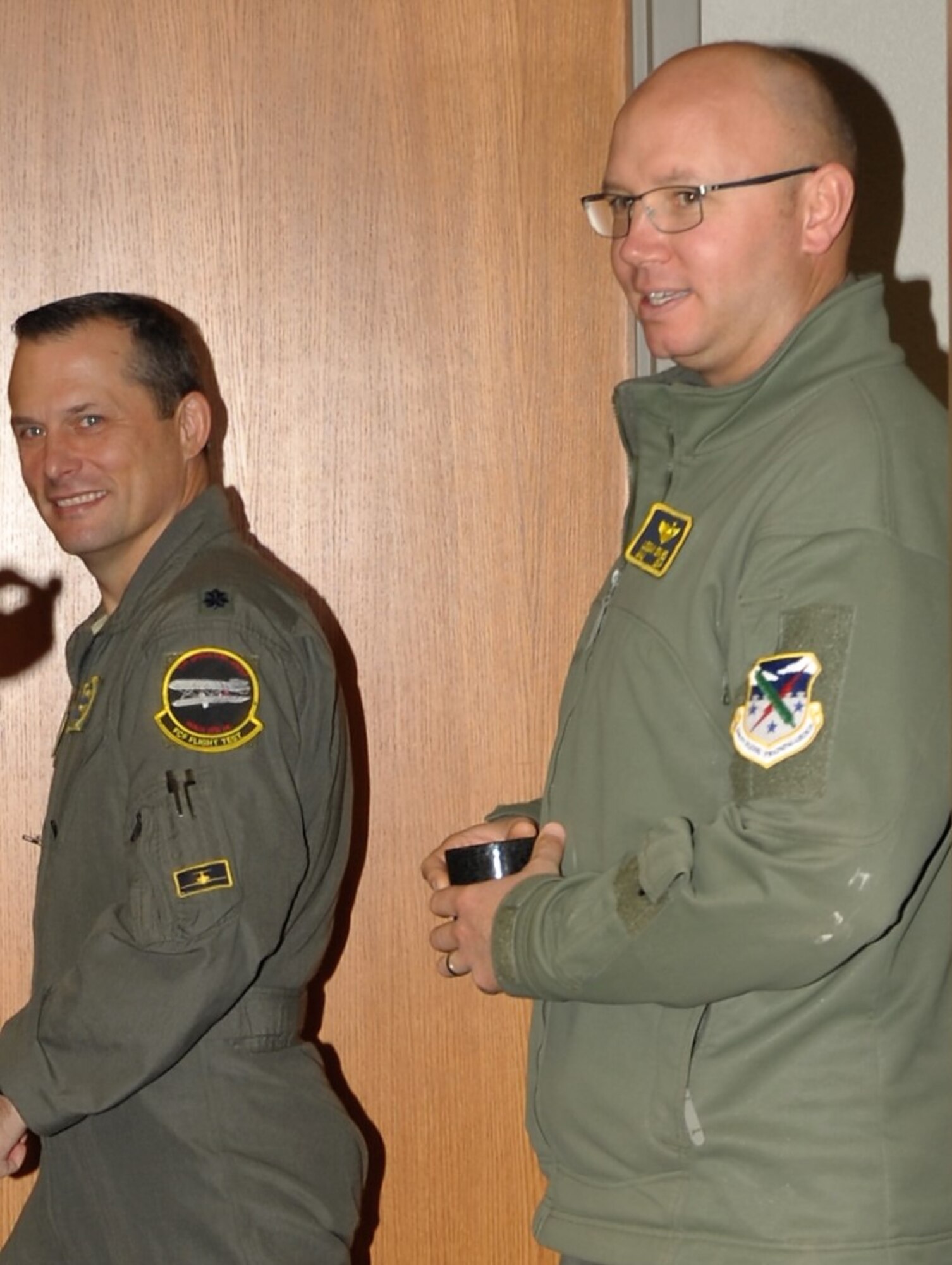 Maj. Logan Draves and Lt. Col. Wes Olson, Air Force Reserve instructor pilots assigned to the 5th Flying Training Squadron, Vance Air Force Base, Oklahoma, head down the hall for a cup of coffee. Draves is also an Enid, Oklahoma Habitat for Humanity board member. (U.S. Air Force photo)