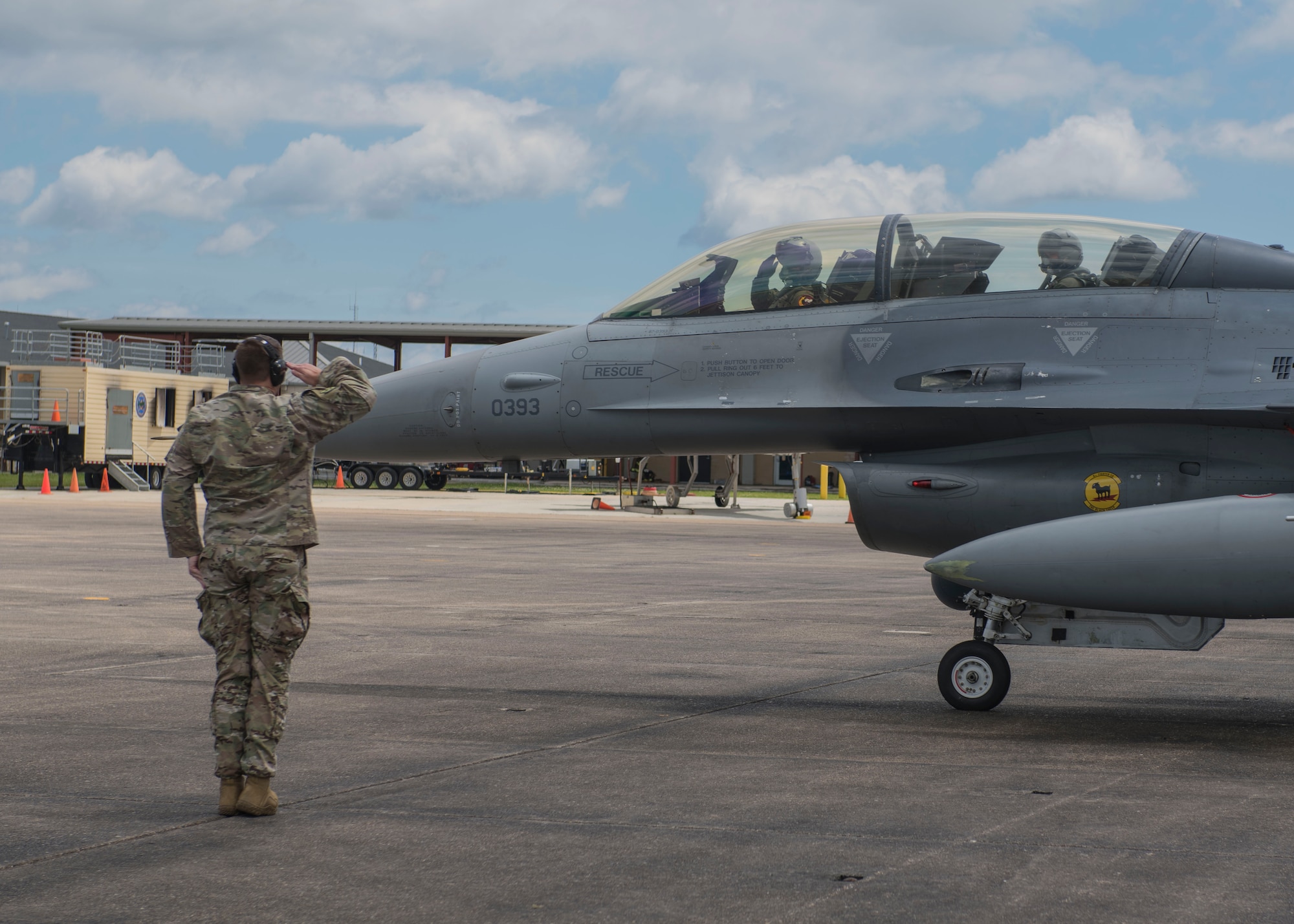 U.S. Air Force Master Sgt. Ryan Gentry salutes an F-16 pilot before a familiarization flight, April 9, 2019, Naval Air Station Joint Reserve Base New Orleans, La., and participated in a training exercise, March 29 to April 12, 2019. Many personnel were given the opportunity to go on a FAM flight in the back of an F-16 D-model during the temporary duty assignment. (U.S. Air Force photo by Airman 1st Class Kindra Stewart)