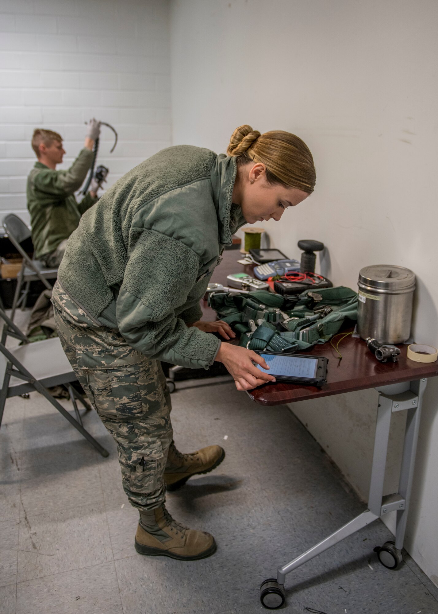 U.S. Air Force Airman Samantha Anderson, 54th Operations Support Squadron Aircrew Flight Equipment apprentice, reads a technical order, April 11, 2019, at Naval Air Station Joint Reserve Base New Orleans, La. AFE spent over two weeks preparing the gear that was used during the temporary duty station. (U.S. Air Force photo by Airman 1st Class Kindra Stewart)