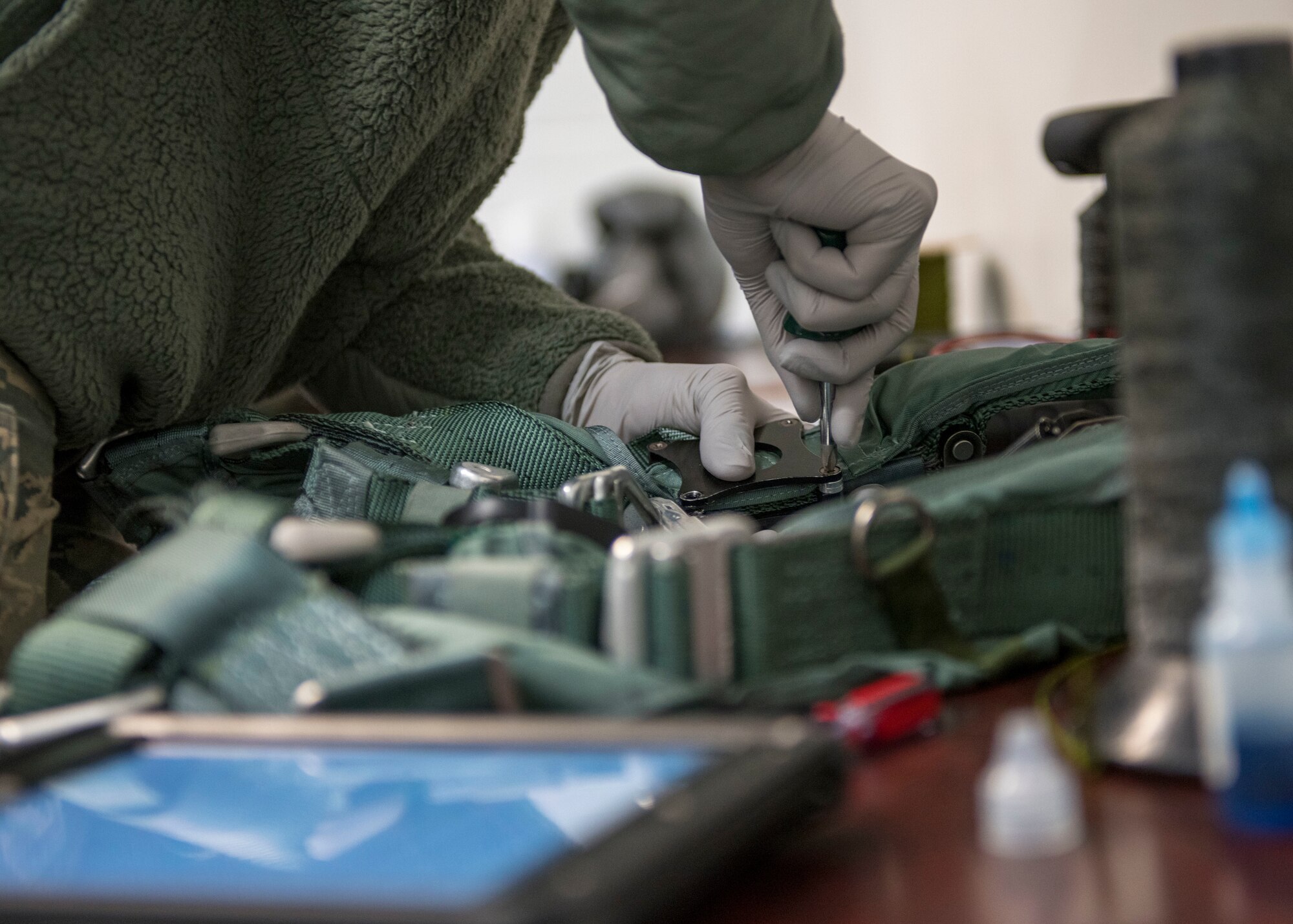 U.S. Air Force Airman Samantha Anderson, 54th Operations Support Squadron Aircrew Flight Equipment apprentice, tightens a screw on a pair of anti-gravity trousers, April 11, 2019, at Naval Air Station Joint Reserve Base New Orleans, La. Because of the gravitational forces the body experiences during a flight in a fighter jet, a special set of trousers, also called the 'G-suit,' must be fit and worn to regulate oxygen levels in the body. (U.S. Air Force photo by Airman 1st Class Kindra Stewart)
