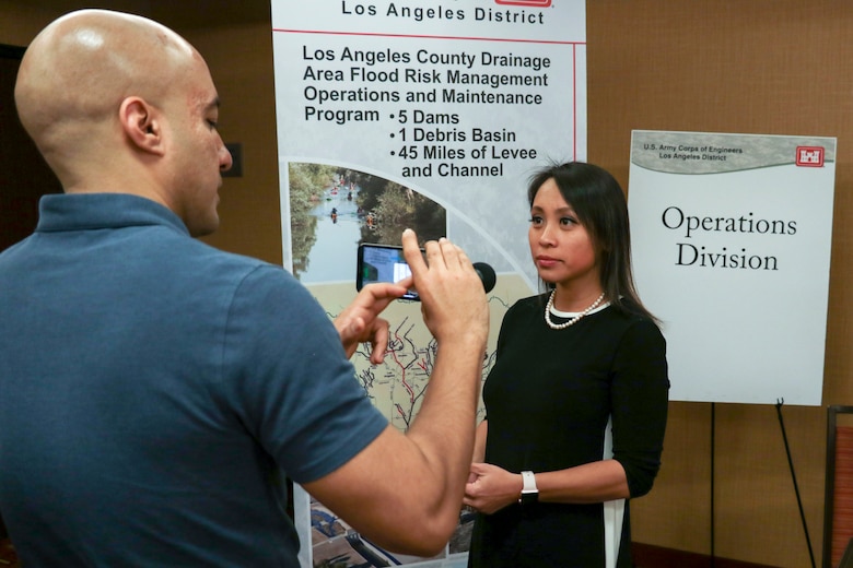 Lillian Doherty, Operations Division chief, speaks with Luciano Vera, public affairs specialist, at the Los Angeles District Arizona-Nevada Area Office's Business Opportunities Open House March 14 in Scottsdale, Arizona. Doherty emphasized the importance of the BOOH's relationship building to help identify what contractors have the capabilities to do the work ... that the Corps needs to get done.