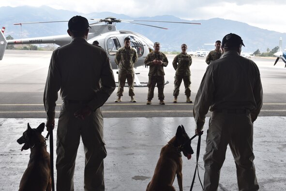 Master Sgt. Brandon VanWalraven, 571st Mobility Support Advisory Squadron mobile training team sergeant, speaks with the Costa Rican Air Vigilance Service dog handlers, April 1, 2019.  The team of six dog-handlers trained from March 26 through April 6 on new dog handling techniques to improved their day-to-day operations at the Juan Santamaria International Airport and other remote posts across Costa Rica. (U.S. Air Force photo by Maj. Noelle DeRuyter)