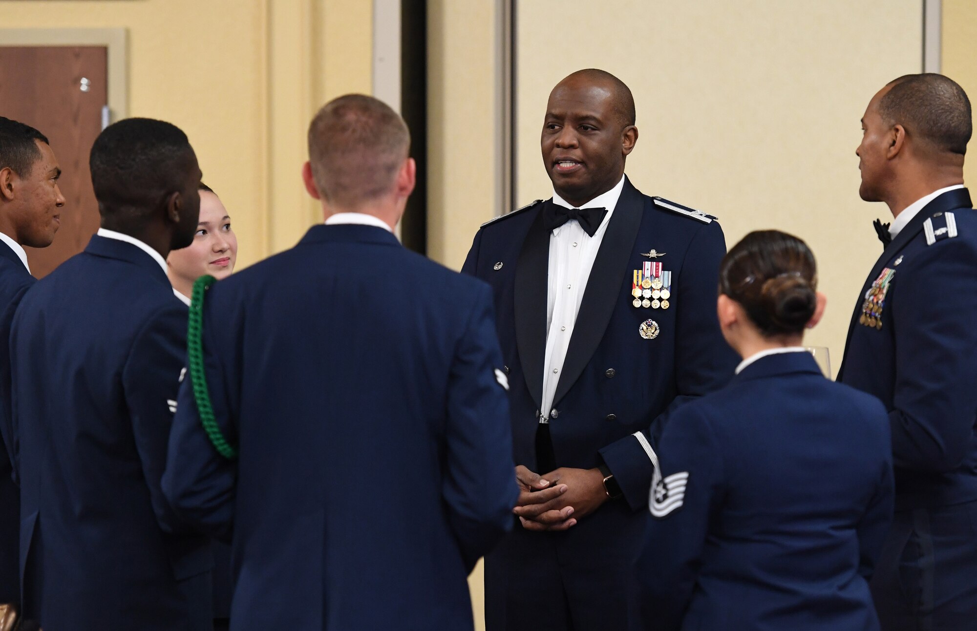 U.S. Air Force Col. Leo Lawson, Jr., 81st Training Group commander, speaks with Airmen during the Airmen In Training Ball at the Bay Breeze Event Center on Keesler Air Force Base, Mississippi, April 19, 2019. The event, hosted by the 81st TRG, is the first of its kind and was  geared toward training Airmen on how to participate and act during a formal military ball so they can feel confident in their abilities when arriving at their follow-on locations. The Airmen served in key positions throughout the ball such as emcees, color guard, POW/MIA table ceremony, national anthem singer and the invocation. (U.S. Air Force photo by Kemberly Groue)