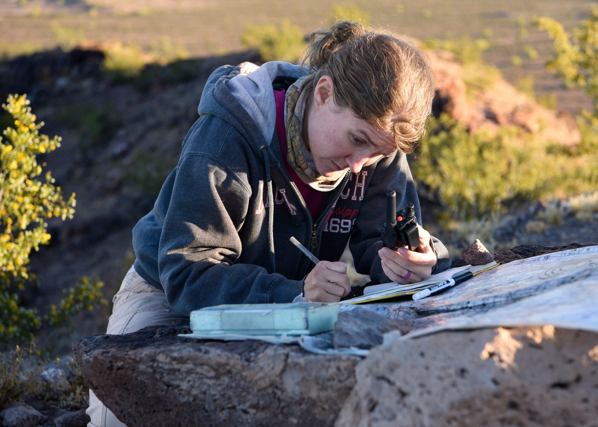 Courtney Kipp, Tunista Services Pronghorn biologist, plots coordinates on a map April 17, 2019, at the Barry M. Goldwater Range East in Wellton, Ariz.