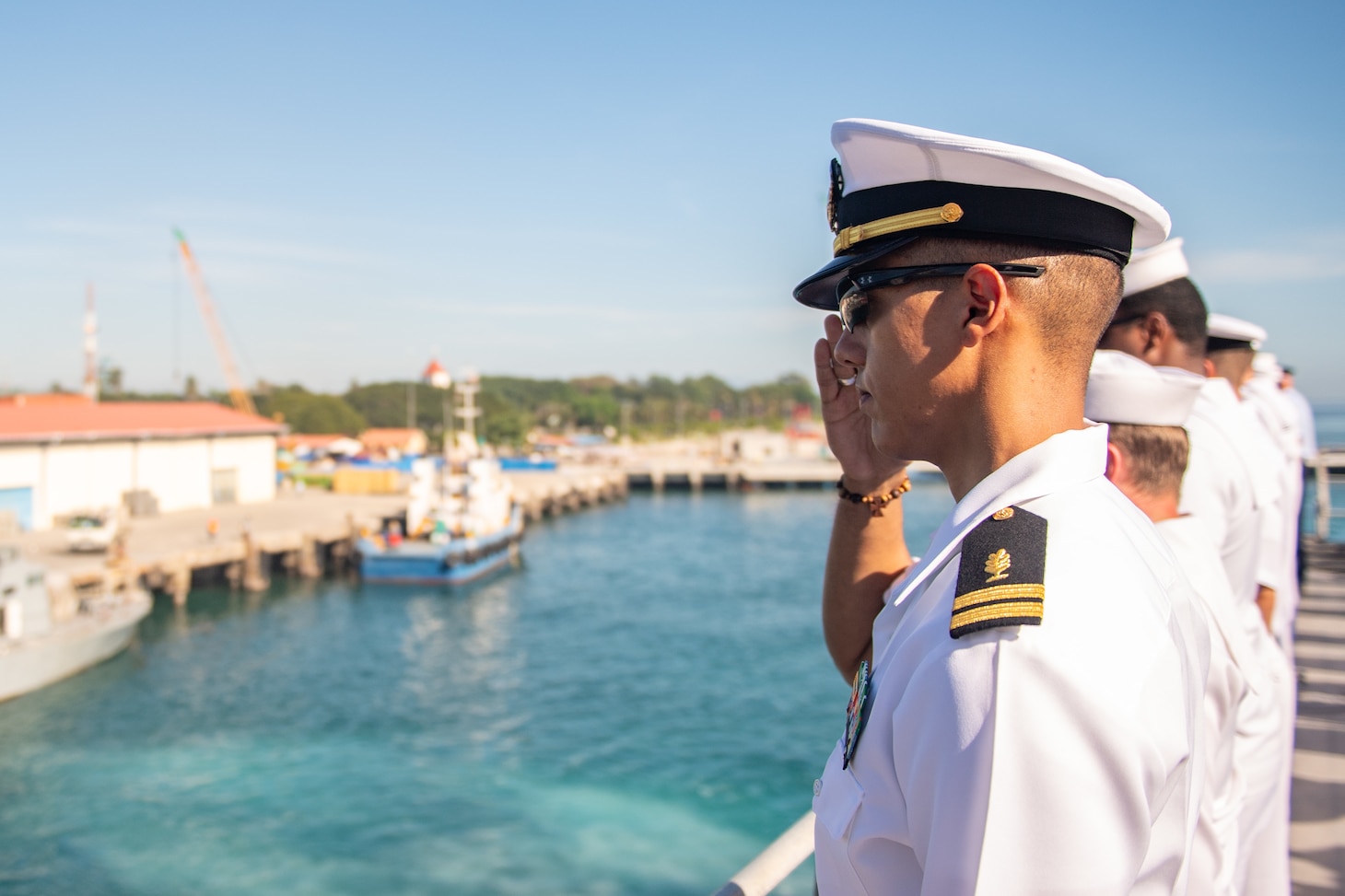 DILI, Timor-Leste (April 22, 2019) – U.S. Navy Lt. Nelson Guadalupe salutes while manning the rails of the fast expeditionary transport ship USNS Fall River (T-EPF 4) during its arrival in Timor-Leste for Pacific Partnership 2019. Pacific Partnership, now in its 14th iteration, is the largest annual multinational humanitarian assistance and disaster relief preparedness mission conducted in the Indo-Pacific. Each year the mission team works collectively with host and partner nations to enhance regional interoperability and disaster response capabilities, increase security and stability in the region, and foster new and enduring friendships in the Indo-Pacific.