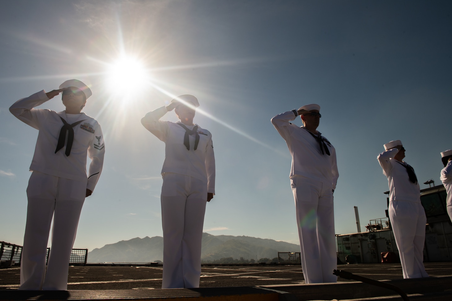 DILI, Timor-Leste (April 22, 2019) – Pacific Partnership 2019 personnel salute while manning the rails of the fast expeditionary transport ship USNS Fall River (T-EPF 4) during its arrival in Timor-Leste. Pacific Partnership, now in its 14th iteration, is the largest annual multinational humanitarian assistance and disaster relief preparedness mission conducted in the Indo-Pacific. Each year the mission team works collectively with host and partner nations to enhance regional interoperability and disaster response capabilities, increase security and stability in the region, and foster new and enduring friendships in the Indo-Pacific.