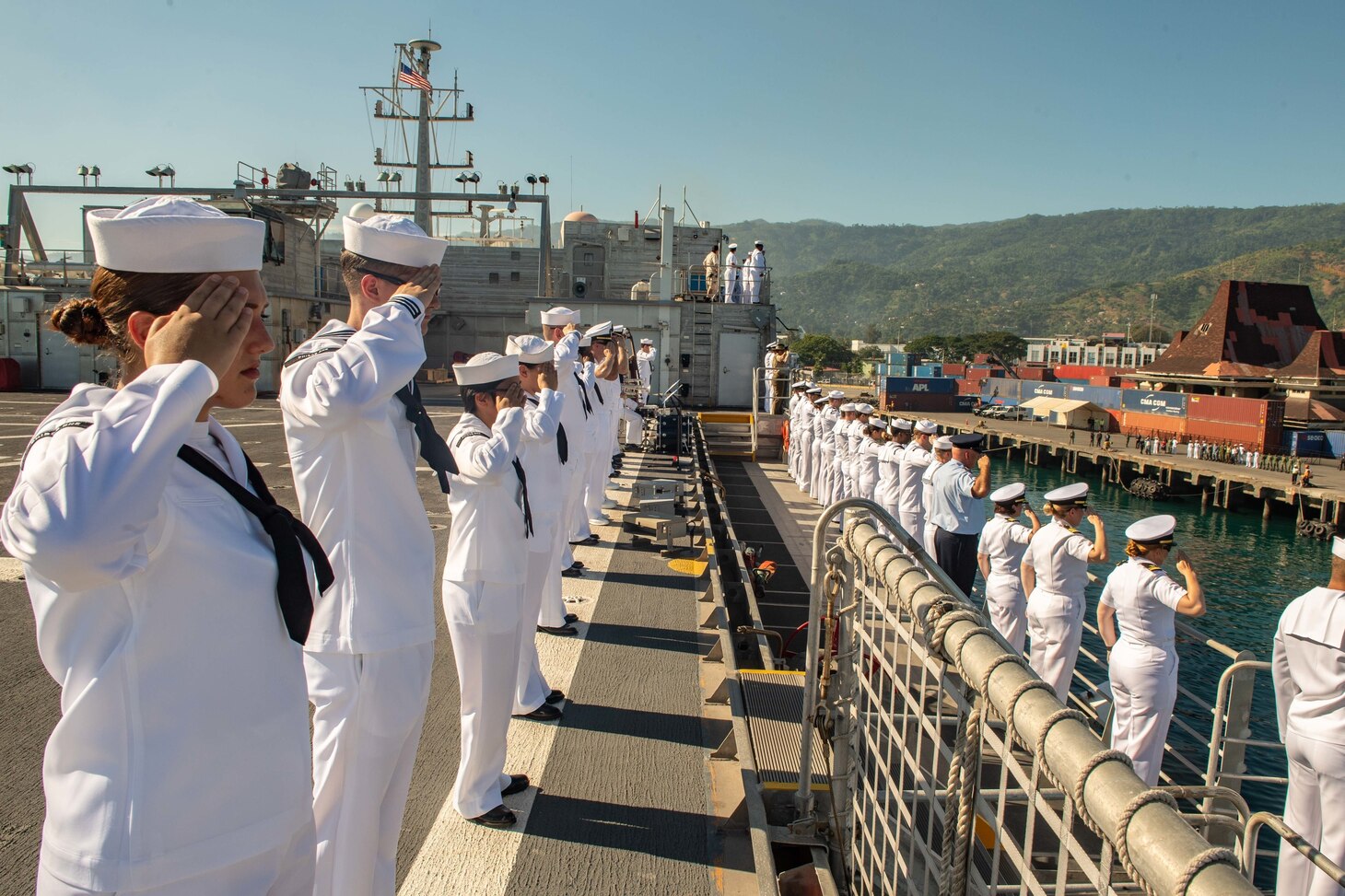 DILI, Timor-Leste (April 22, 2019) – Pacific Partnership 2019 personnel salute while manning the rails of the fast expeditionary transport ship USNS Fall River (T-EPF 4) during its arrival in Timor Leste. Pacific Partnership, now in its 14th iteration, is the largest annual multinational humanitarian assistance and disaster relief preparedness mission conducted in the Indo-Pacific. Each year the mission team works collectively with host and partner nations to enhance regional interoperability and disaster response capabilities, increase security and stability in the region, and foster new and enduring friendships in the Indo-Pacific.
