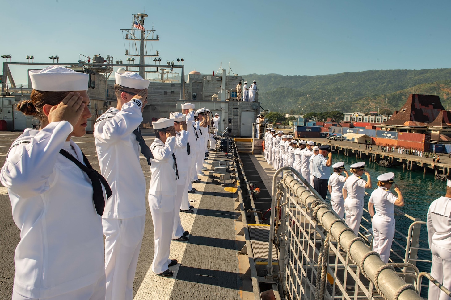 DILI, Timor-Leste (April 22, 2019) – Pacific Partnership 2019 personnel salute while manning the rails of the fast expeditionary transport ship USNS Fall River (T-EPF 4) during its arrival in Timor Leste. Pacific Partnership, now in its 14th iteration, is the largest annual multinational humanitarian assistance and disaster relief preparedness mission conducted in the Indo-Pacific. Each year the mission team works collectively with host and partner nations to enhance regional interoperability and disaster response capabilities, increase security and stability in the region, and foster new and enduring friendships in the Indo-Pacific.