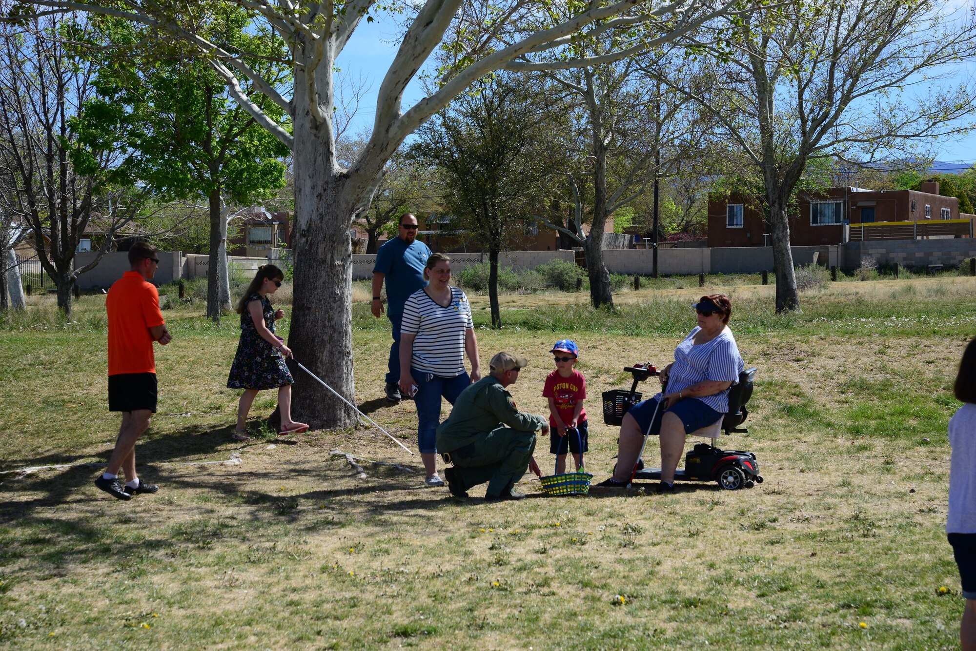 Sgt. Zac Cancilla of the Albuquerque Police Department Bomb Squad assists members of the community during the third annual Beeping Easter Egg Hunt at Loma Linda Park in Albuquerque, NM, April 20, 2019. The eggs, made by the EOD with a beeping mechanism, were hidden throughout the park for blind or impaired vision children to find and trade in for candy and prizes. An EOD robot and suit were also on display for hands on exploration and questions. (U.S. Air Force video by Jessie Perkins)