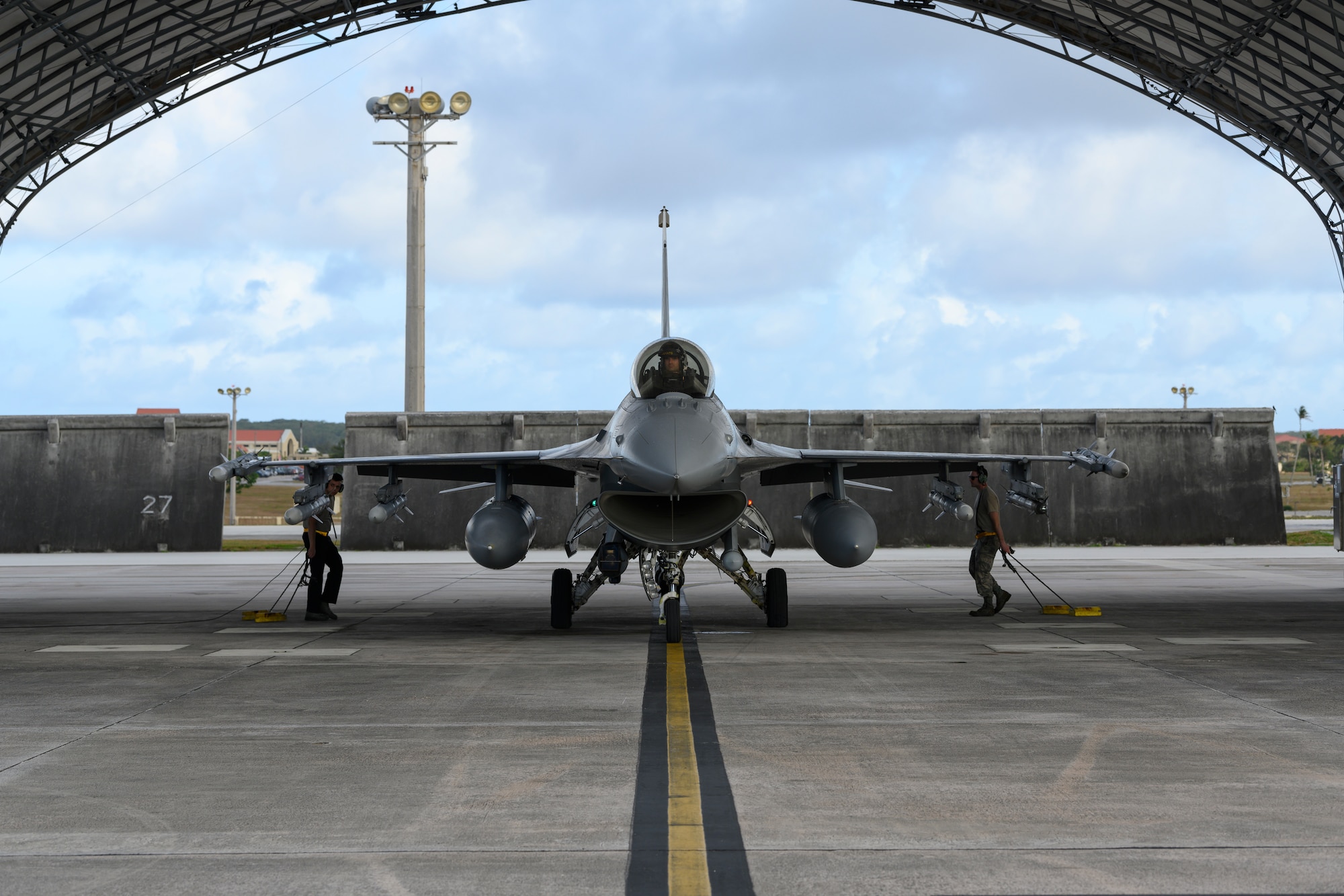 U.S. Air Force crew chiefs assigned to the 35th Fighter Wing put chocks down to secure a U.S. Air Force F-16 Fighting Falcon at Andersen Air Force Base, Guam, April 22, 2019.