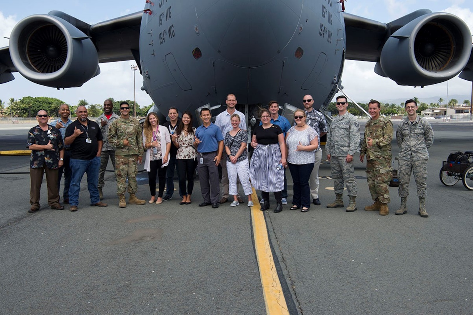 Airmen assigned to the 15th Aircraft Maintenance Squadron and Hawaiian Airlines maintainers pose for a photo in front of a C-17 Globemaster III on Joint Base Pearl Harbor-Hickam, Hawaii April 12, 2019. The 15th AMXS hosted Hawaiian Airlines as part of a continuous process improvement event to talk shop about maintenance, both military and civilian. (U.S. Air Force photo by 2nd Lt. Amber R. Kelly-Herard)