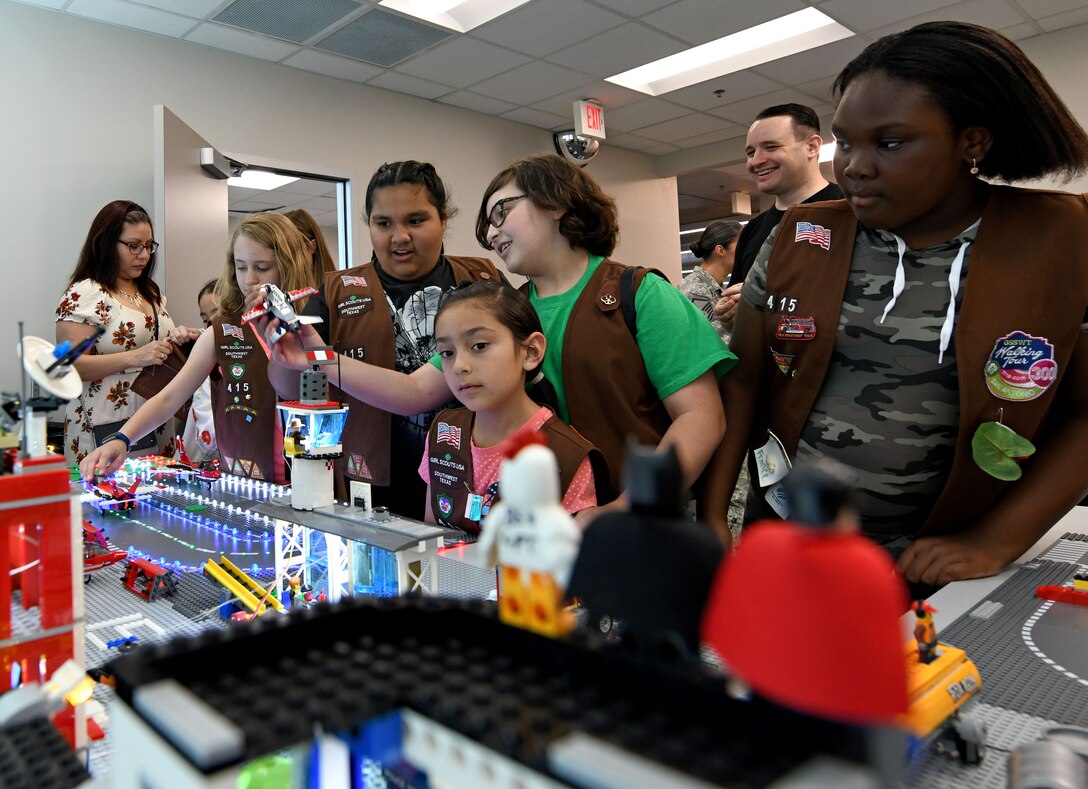 San Antonio-area Girl Scouts visit the 90th Cyberspace Operations Squadron “Bricks in the Loop” for a tour April 19, 2019. “Bricks in the Loop” mimics an Air Force installation with items such as a fire station, police station, airport, jets and tanker trucks, all used to simulate real-world cyber systems in training cyber operators. (U.S. Air Force photo by Tech. Sgt. R.J. Biermann)