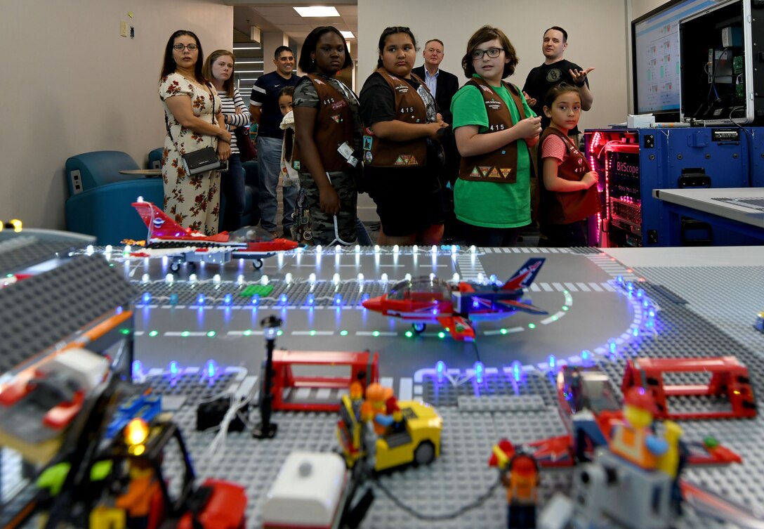 San Antonio-area Girl Scouts visit the 90th Cyberspace Operations Squadron “Bricks in the Loop” for a tour April 19, 2019. “Bricks in the Loop” mimics an Air Force installation with items such as a fire station, police station, airport, jets and tanker trucks, all used to simulate real-world cyber systems in training cyber operators. (U.S. Air Force photo by Tech. Sgt. R.J. Biermann)