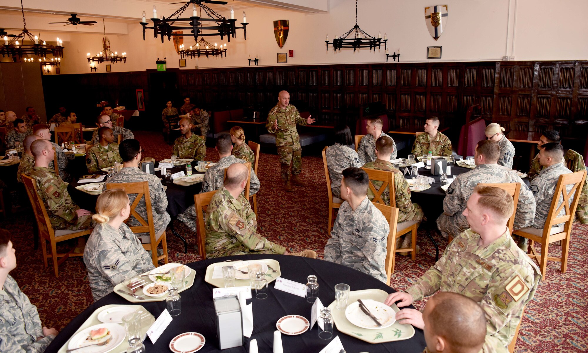 U.S. Air Force Chief Master Sgt. Anthony Cruz Munoz speaks with 100th Air Refueling Wing Airmen during lunch at the Gateway Dining Facility at RAF Mildenhall, England, April 3, 2019. Third AF leadership discussed infrastructure development with wing leadership and met with 100th Air Refueling Wing Airmen. (U.S. Air Force photo by Airman 1st Class Brandon Esau)