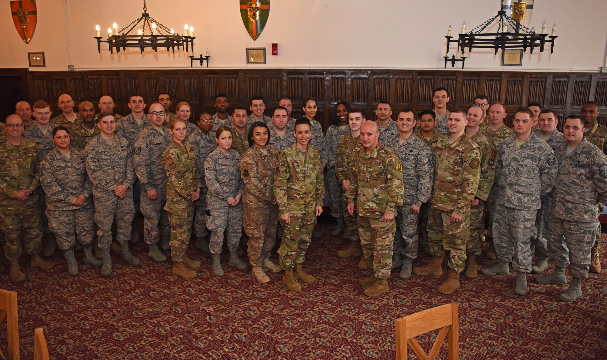 U.S. Air Force Chief Master Sgt. Anthony Cruz Munoz, Third Air Force command chief, poses for a photo with Airmen of the 100th Air Refueling Wing at RAF Mildenhall, England, April 3, 2019. Third AF leadership toured the 100th Logistics Readiness Squadron hangar, the 100th Communications Squadron control facility and the 100th Maintenance Squadron aircraft ground equipment shop. (U.S. Air Force photo by Airman 1st Class Brandon Esau)