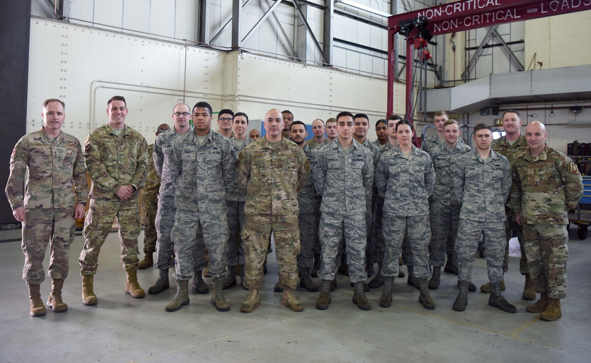 U.S. Air Force Maj. Gen. John Wood, Third Air Force commander, and U.S. Air Force Chief Master Sgt. Anthony Cruz Munoz, Third AF command chief, pose for a photo with Airmen of the 100th Maintenance Squadron aircraft ground equipment shop at RAF Mildenhall, England, April 3, 2019. Third AF leadership also toured the 100th Logistics Readiness Squadron hangar, the 100th Communications Squadron control facility and with Airmen of the 100th Security Forces Squadron. (U.S. Air Force photo by Airman 1st Class Brandon Esau)