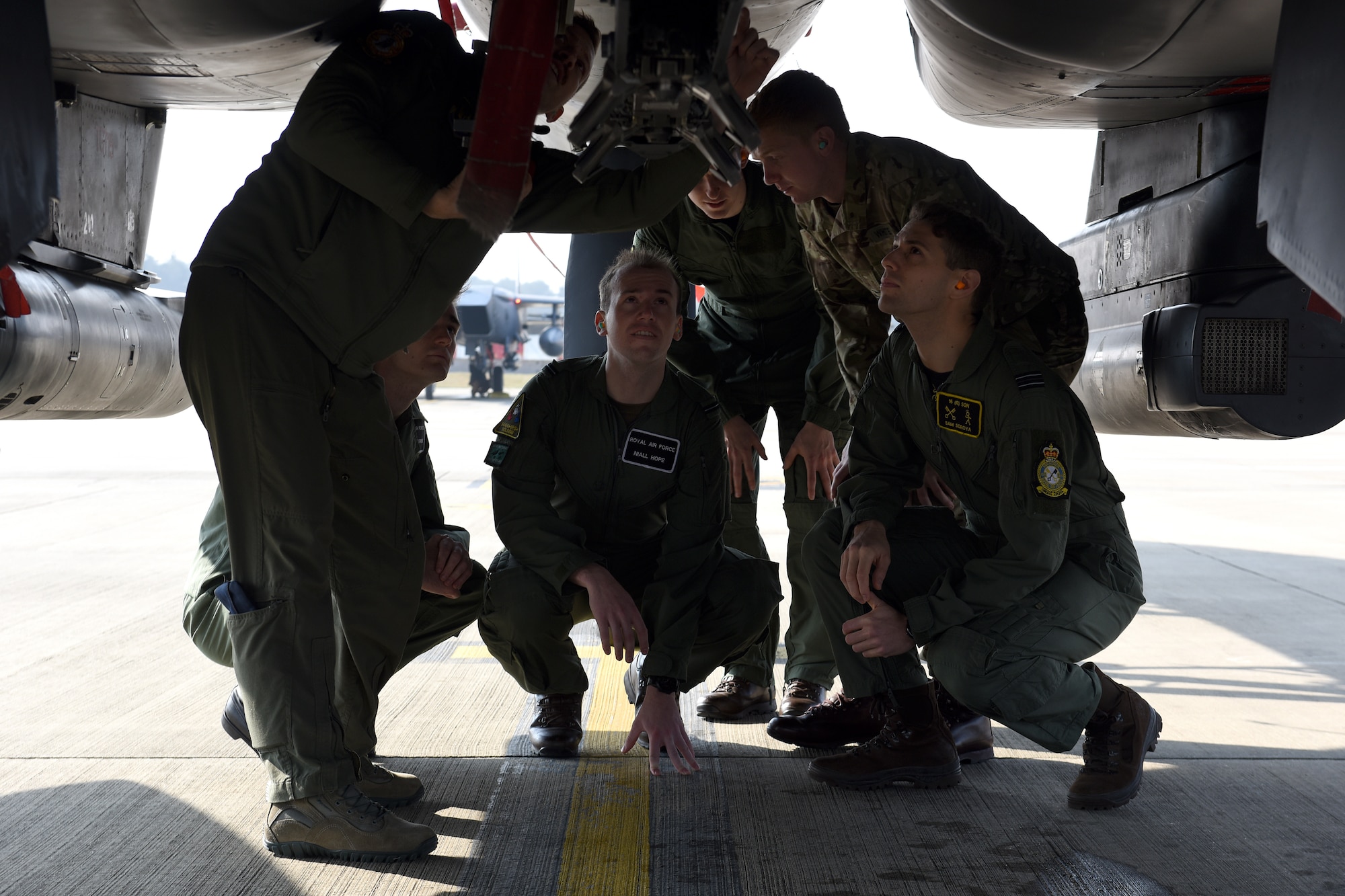 A 494th Fighter Squadron weapon systems officer shows Royal Air Force Cosford holding officers parts of an F-15E Strike Eagle at RAF Lakenheath, England, April 18, 2019. The officers viewed aircraft on the flight line as well as had the opportunity to talk to pilots about their experiences, both in training and operationally. (U.S. Air Force photo by Airman 1st Class Madeline Herzog)