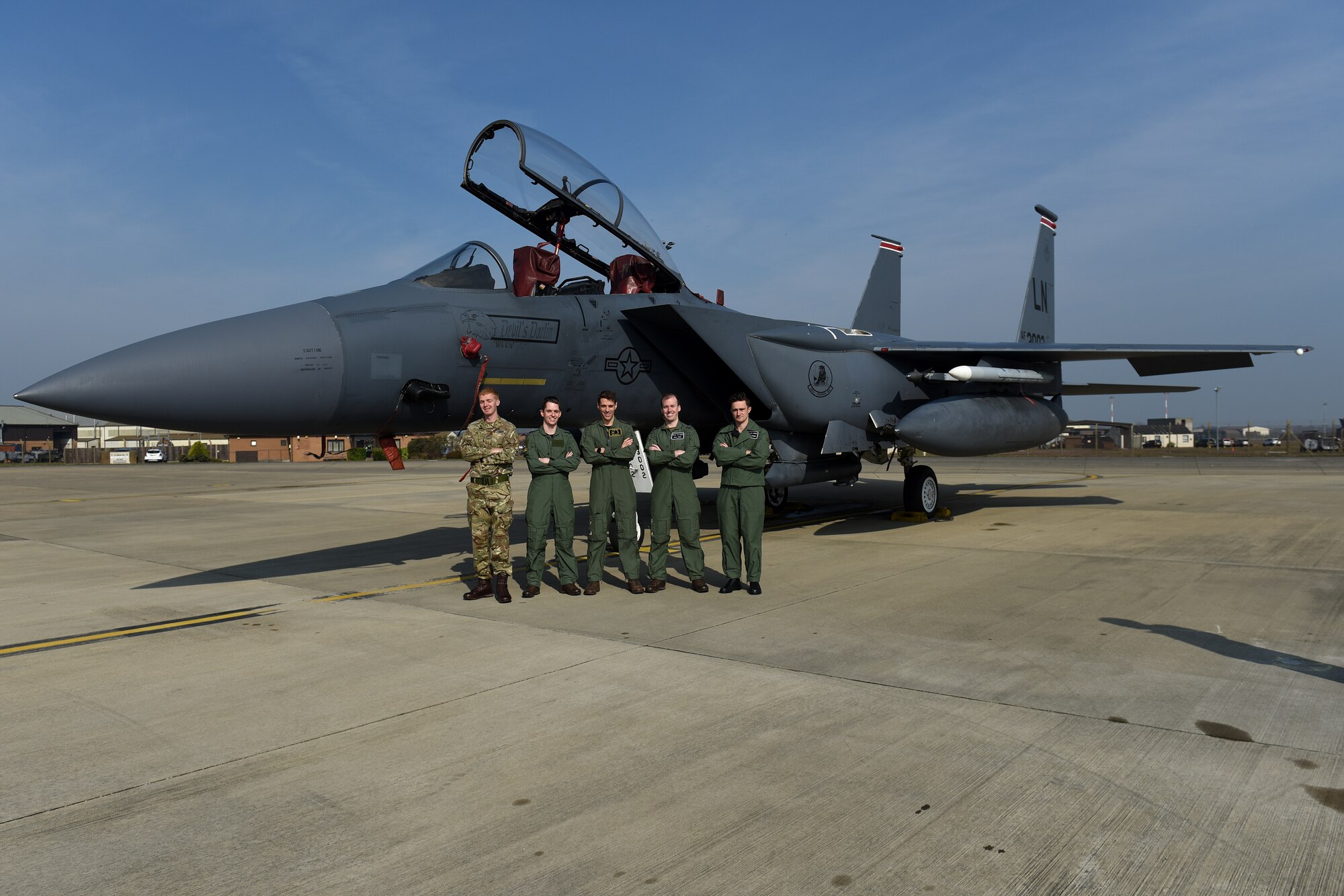 Holding officers from Royal Air Force Cosford pose for a group photo in front of an F-15E Strike Eagle at RAF Lakenheath, England, April 18, 2019. The officers viewed aircraft on the flight line as well as had the opportunity to talk to pilots about their experiences, both in training and operationally. (U.S. Air Force photo by Airman 1st Class Madeline Herzog)