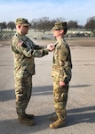 Lt. Col. Joshua Stewart, a division chief with the U.S. Transportation Command, headquartered at Scott Air Force Base, Illinois, presents Spc. Taylen Winchell of Lamar, Missouri, a member of the Missouri Army National Guard, with the Joint Service Achievement Medal at Jefferson Barracks, near St. Louis, April 6, 2019.