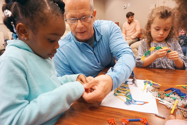 Barney Schulte, technical engineer for the U.S. Army Corps of Engineers Nashville District, helps Melody Jackson and Lilly Mendoza build a bridge April 19, 2019 at the 'Bring your family to Work Day' at the Nashville District Headquarters in Nashville, Tenn. (USACE photo by Mark Rankin)