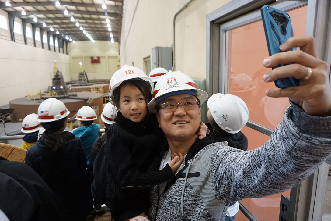 Joon Lee, geologist for the U.S. Army Corps of Engineers Nashville District, takes a selfie picture of his daughter Olivia during a tour of the Old Hickory Dam Power Plant April 19, 2019. (USACE photo by Mark Rankin)