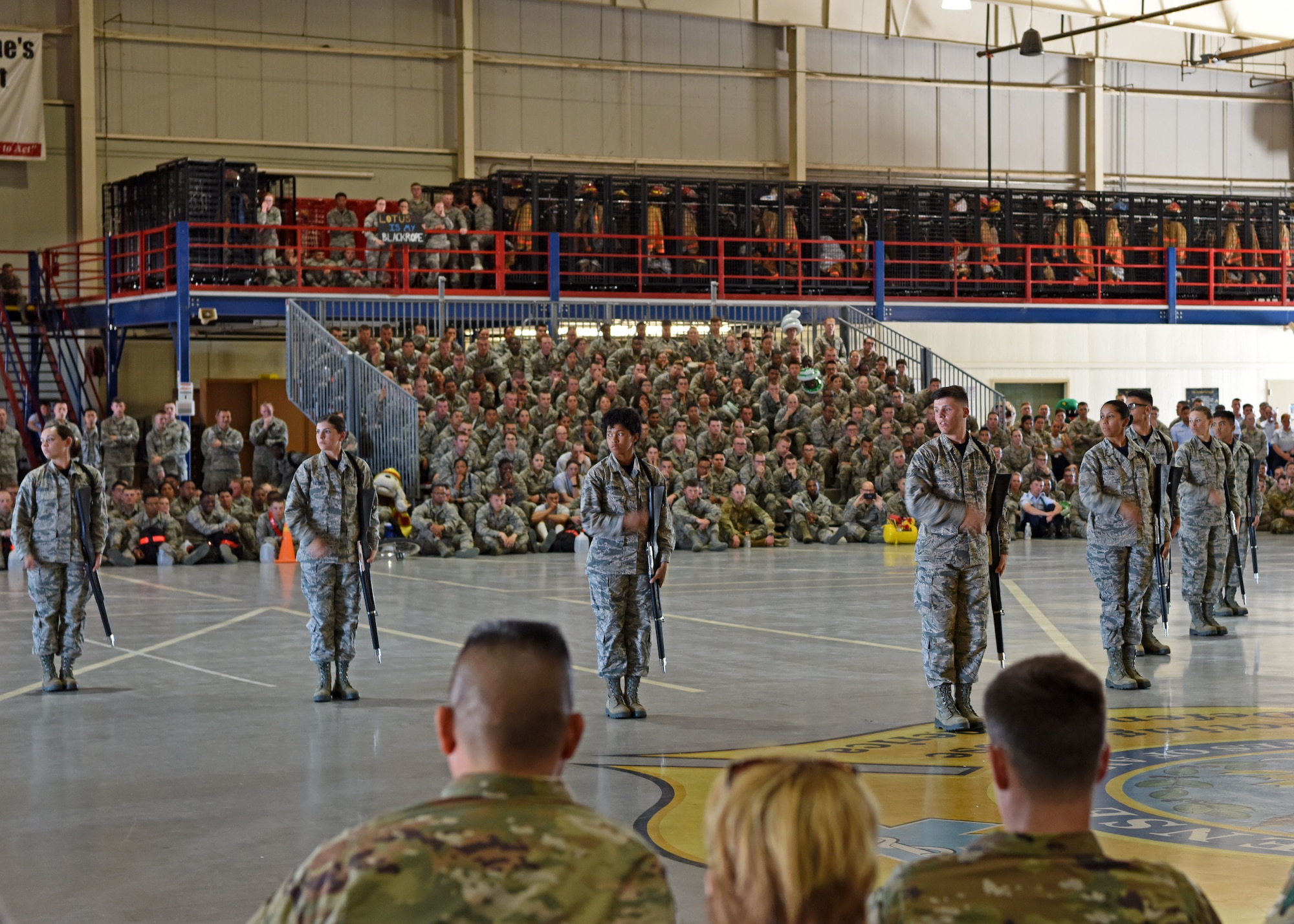 The 315th Training Squadron shows off their rifle routine by doing synchronized flourishes during the drill competition at the Louis F. Garland Department of Defense Fire Academy on Goodfellow Air Force Base, Texas, April 19, 2019. The rifle routine is just one segment in which the three squadrons competed. (U.S. Air Force photo by Airman 1st Class Ethan Sherwood/Released)