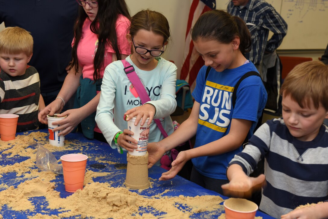 Kids layered pieces of screens inside a cup of sand and demonstrated how they stabilized the sand once removed from the cup during a practical geology exercise. They were participating in the U.S. Army Corps of Engineers Nashville District Bring Your Family to Work Day April 19, 2019 at the Nashville District Headquarters in Nashville, Tenn.  (USACE photo by Lee Roberts)