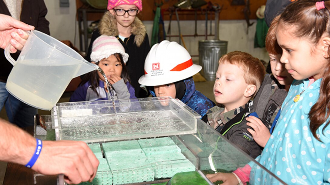 Kids participate in a practical exercise to learn about how development affects waterways and wetlands during the U.S. Army Corps of Engineers Nashville District Bring Your Family to Work Day April 19, 2019 at Old Hickory Dam on the Cumberland River in Old Hickory, Tenn.  (USACE photo by Lee Roberts)