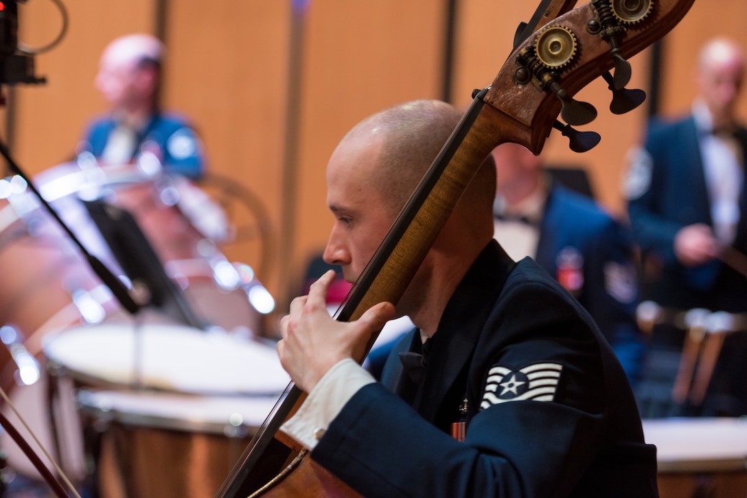 Bassist Technical Sgt. Jonathan Davies performs during the final concert of The U.S. Air Force Band's 2019 Guest Artist Series. The concert featured internationally acclaimed saxophonist Joe Lulloff. (U.S. Air Force photo by Master Sgt. Grant Langford)