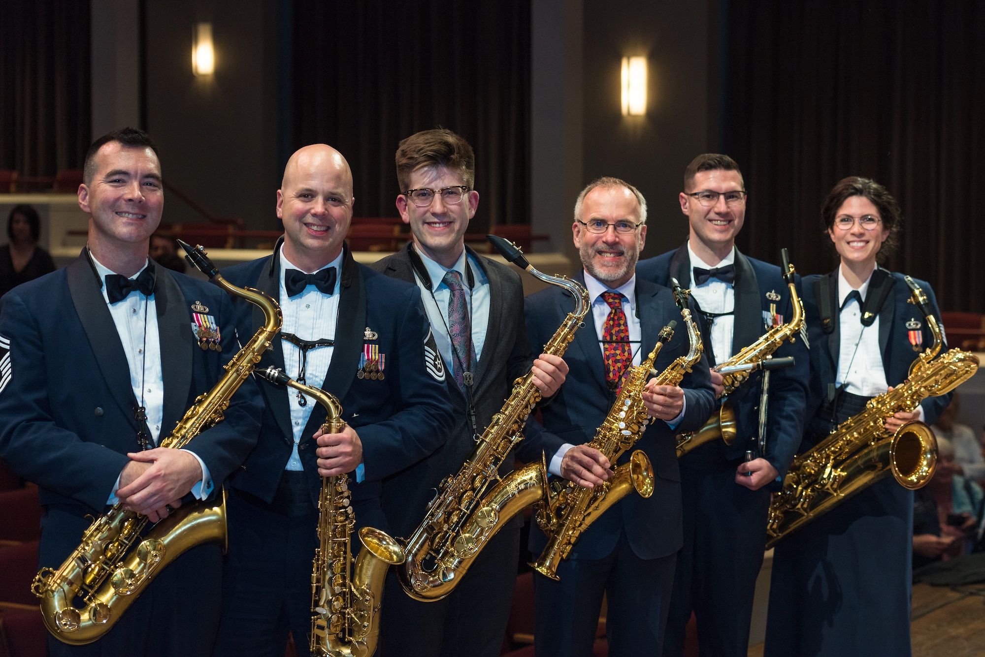 Internationally acclaimed saxophonist Joe Lulloff and his son, Jordan Lulloff, pose with the saxophone section of the U.S. Air Force Concert Band on Thursday, Apr. 18, at the Rachel M. Schlesinger Concert Hall and Arts Center in Alexandria, Virginia. Joe Lulloff and Jordan Lulloff performed on the final installment of The U.S. Air Force Band's 2019 Guest Artist Series. (U.S. Air Force photo by Master Sgt. Grant Langford)