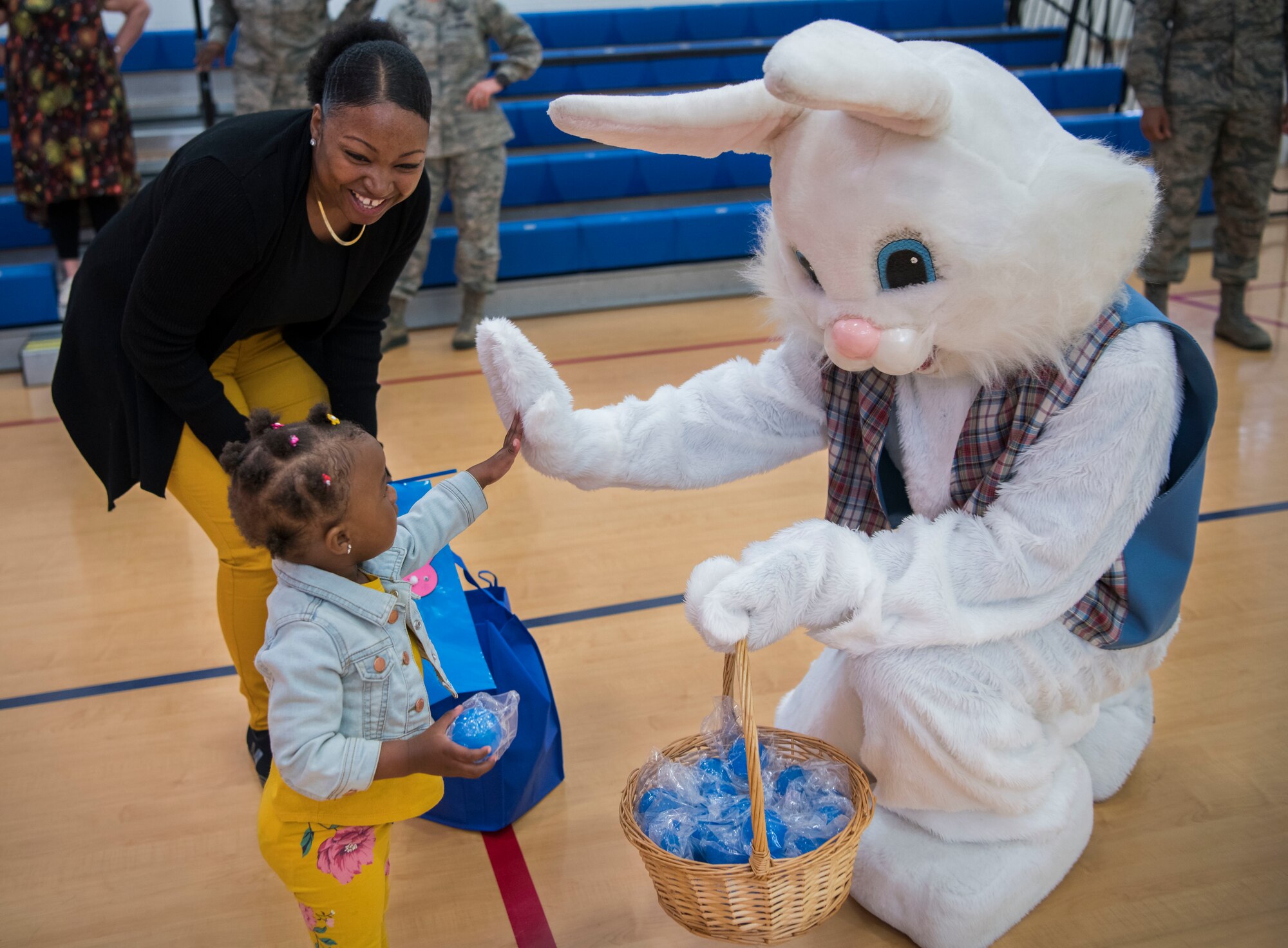 Mariah Corbin high-fives the Easter Bunny the Family Advocacy Program’s Play Group Easter Egg Hunt held in recognition of National Child Abuse Prevention Month on April 17, 2019, at Dover Air Force Base, Del. The Family Advocacy Program’s victim advocates provide service management, counseling, support, safety planning and follow-up services to survivors of domestic violence and their families. (U.S. Air Force photo by Senior Airman Christopher Quail)