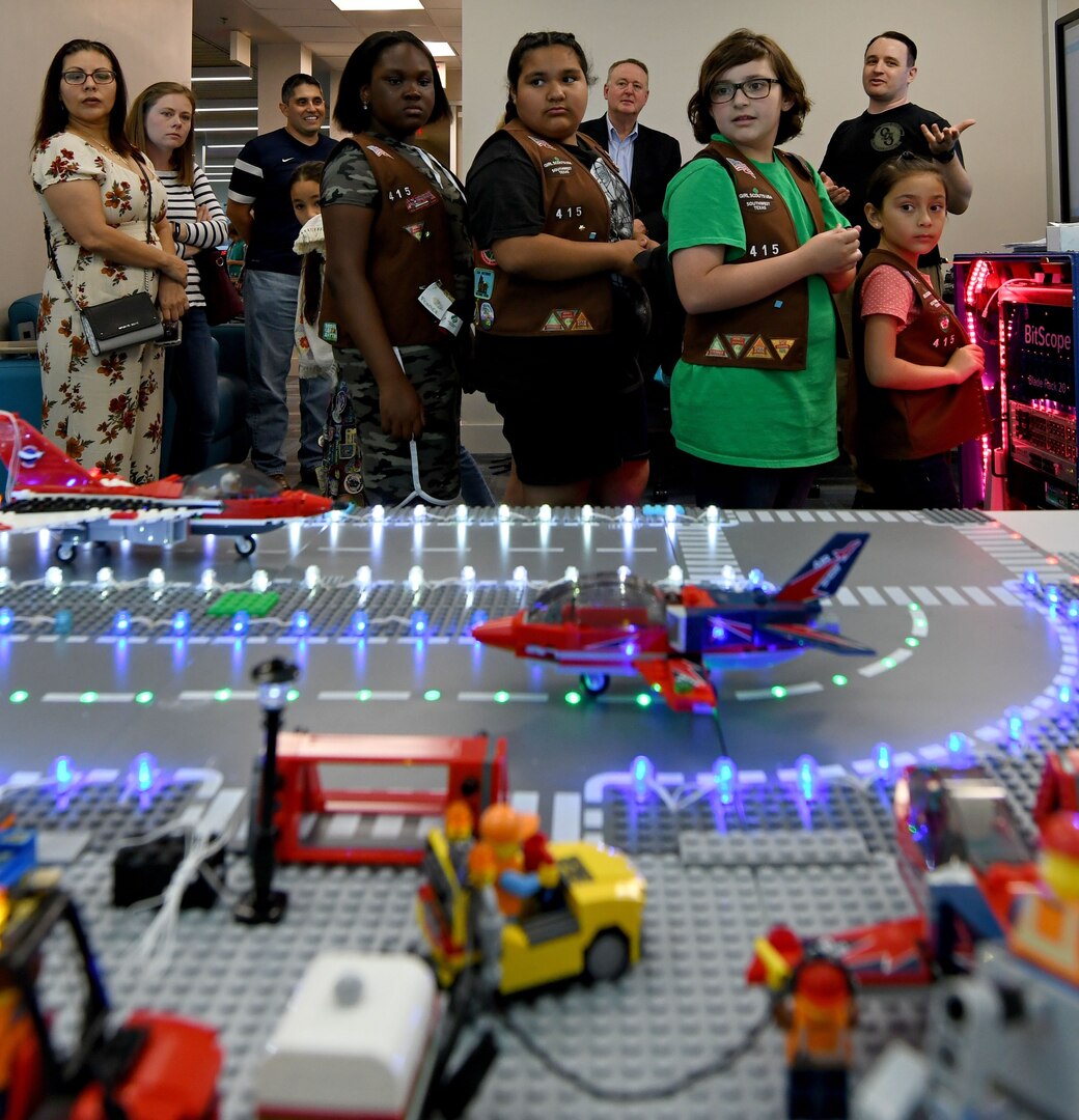 San Antonio-area Girl Scouts visit the 90th Cyberspace Operations Squadron “Bricks in the Loop” at Joint Base San Antonio-Lackland for a tour April 19. “Bricks in the Loop” mimics an Air Force installation with items such as a fire station, police station, airport, jets and tanker trucks, all used to simulate real-world cyber systems in training cyber operators.