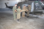 Air advisors from the 571 Mobility Support Advisory Squadron, and Guatemalan air force students practice loading a litter patient into the partner nation’s UH-1 aircraft during a mobile training mission at Aurora Air Base in Guatemala. The students are part of the first aeromedical evacuation unit in the Guatemalan air force. (Courtesy Photo)